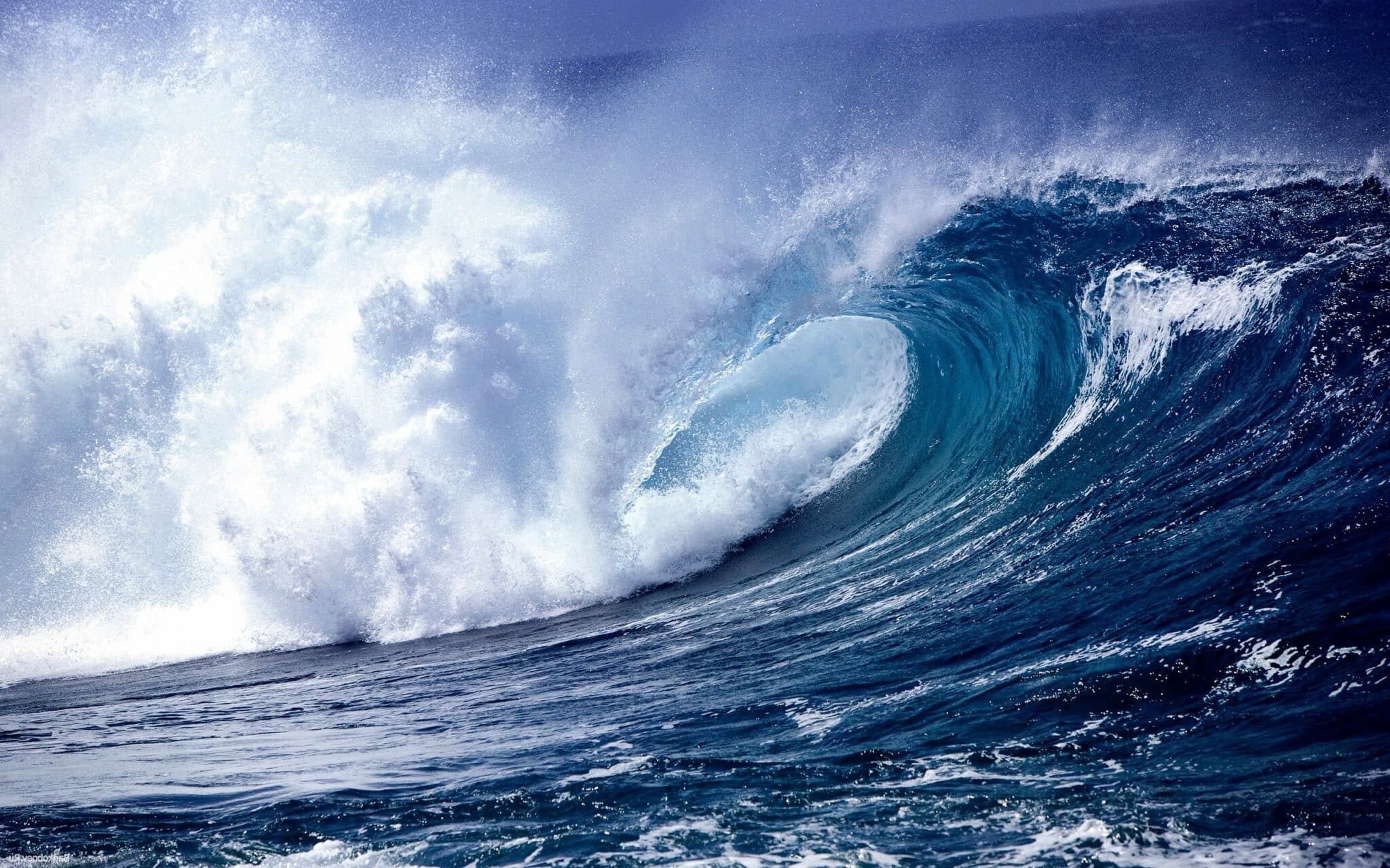 a man riding a wave on a surfboard in the water